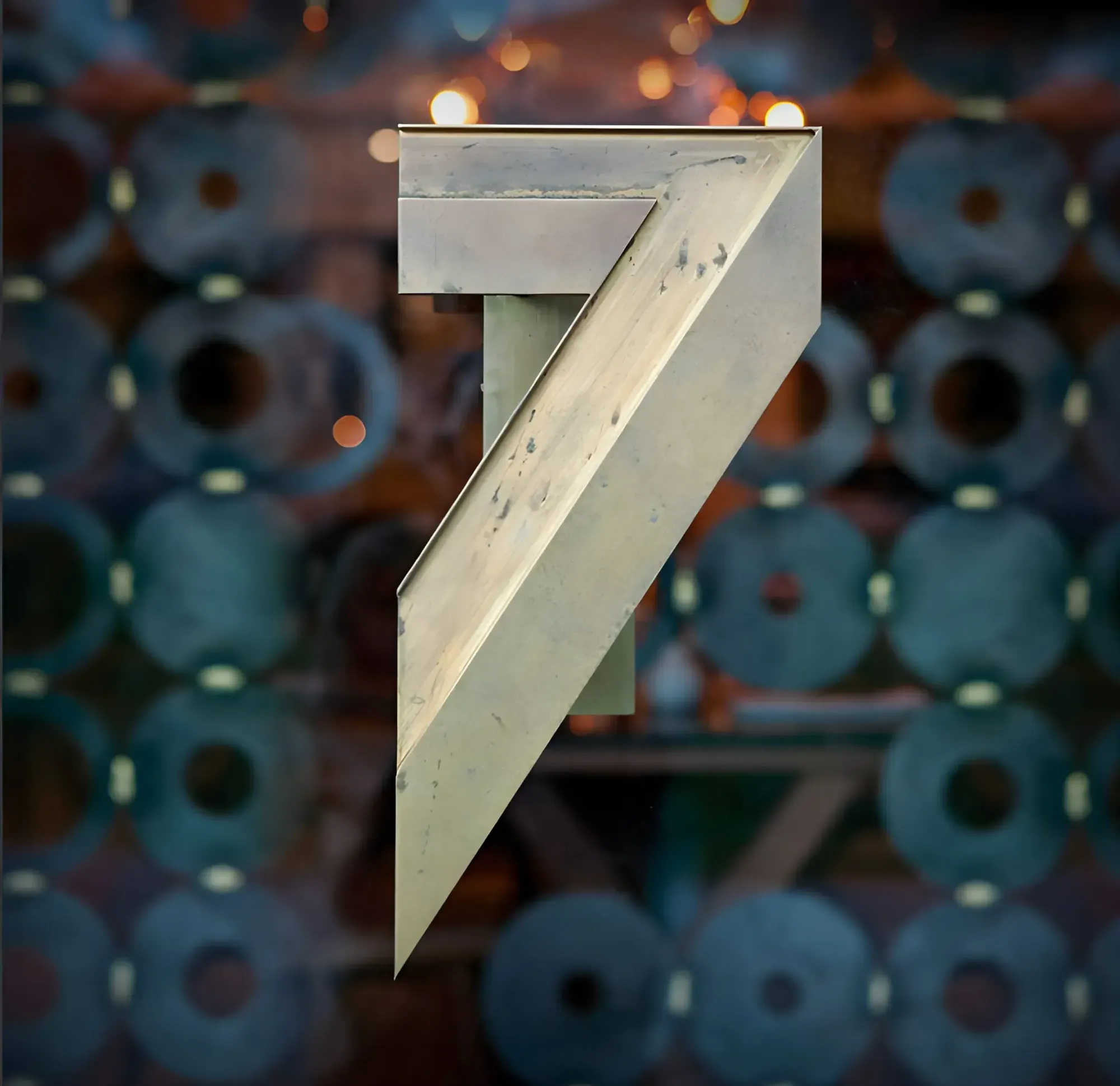 Sculptural metal number 7 in front of a wall of round decorative panels
