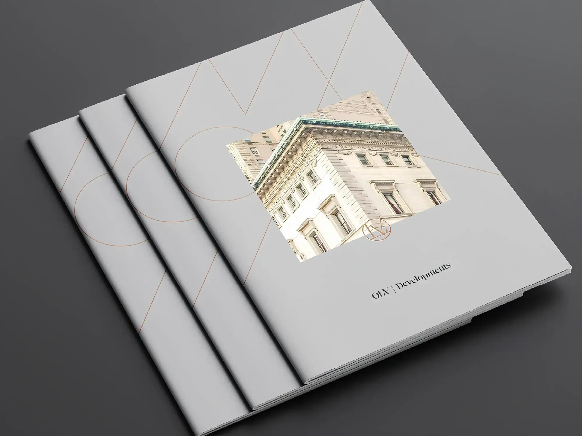 Stack of OLV Developments brochures with a classical building photo and fine line patterns