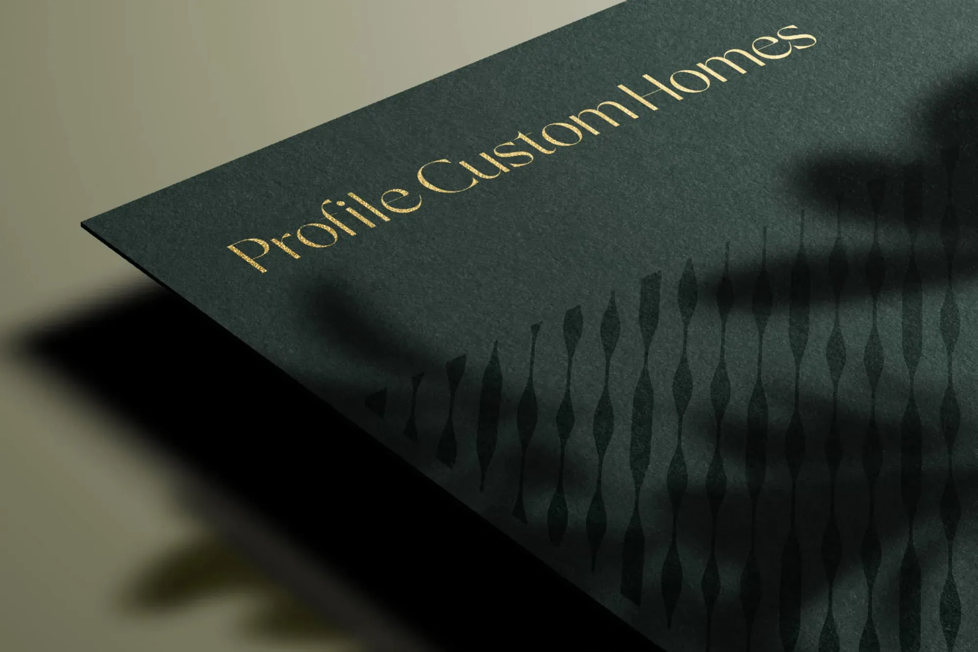 Profile Custom Homes wordmark in gold foil on deep green stationery