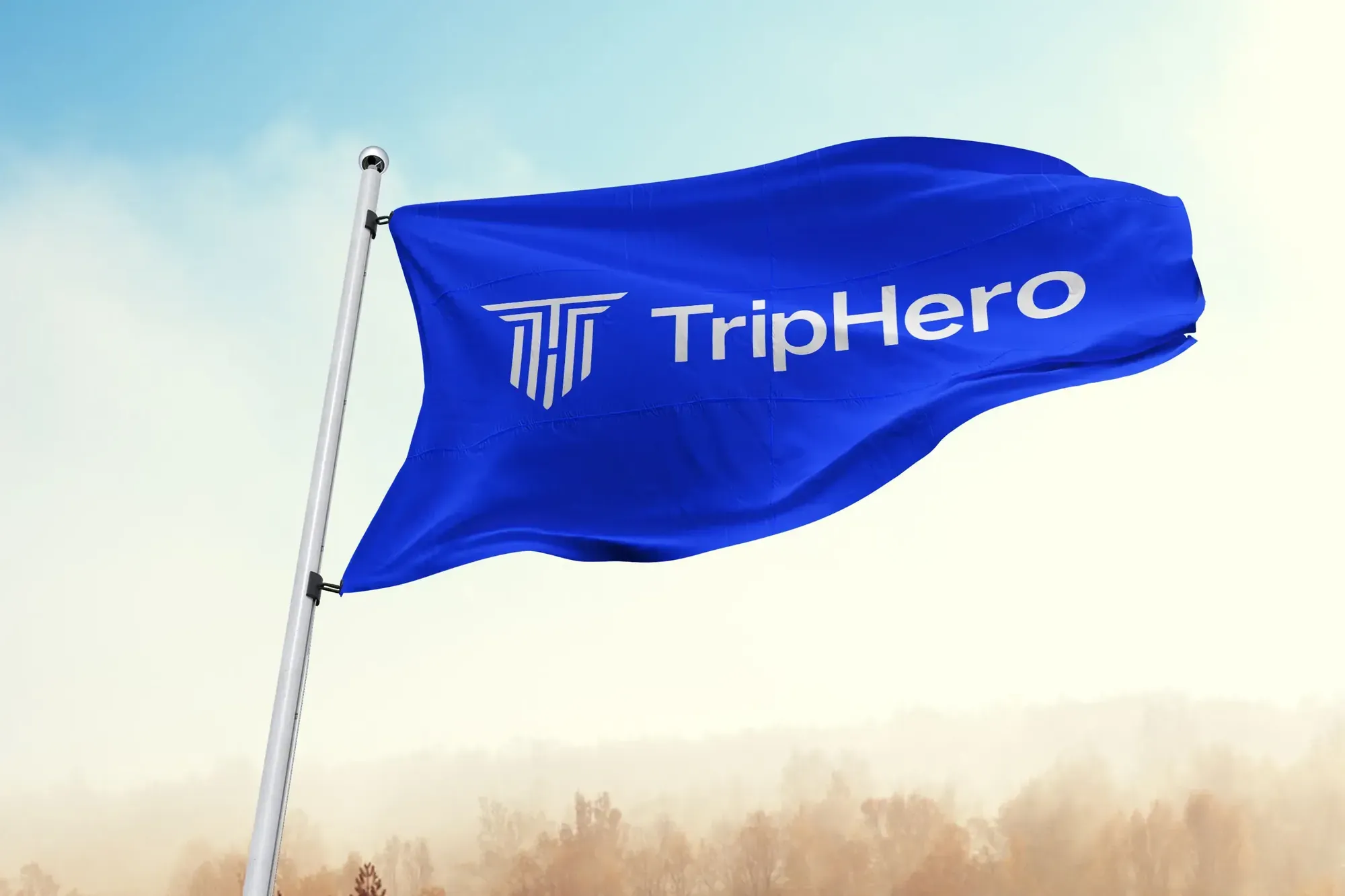 Blue TripHero flag with the brand logo flying against a bright sky